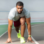 Athlete runner on a track focused after taking supplements