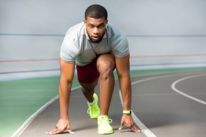 Athlete runner on a track focused after taking supplements