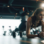 woman doing plank exercises after taking supplements for energy