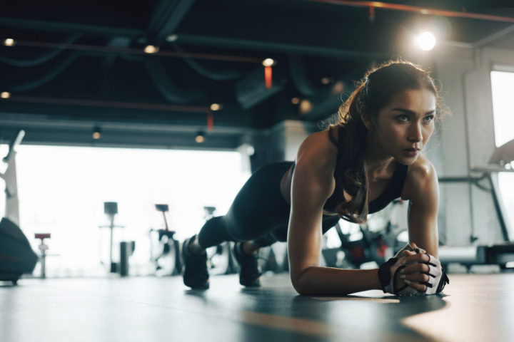 woman doing plank exercises after taking supplements for energy